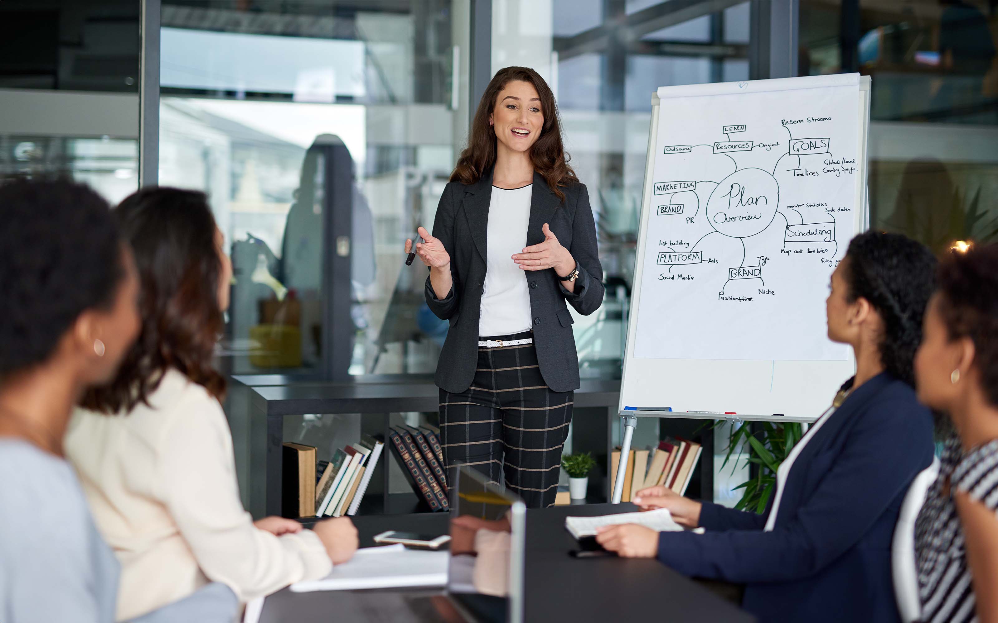 businesswoman-giving-a-presentation-629303228