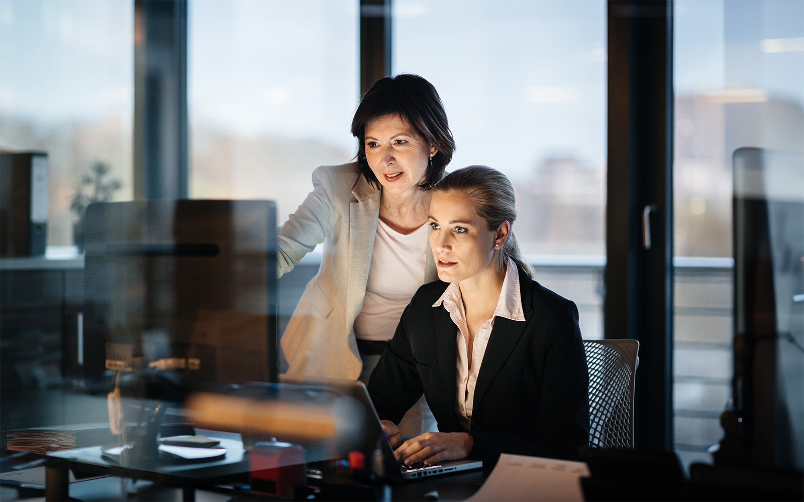 young-and-mature-business-woman-working-late-512904938