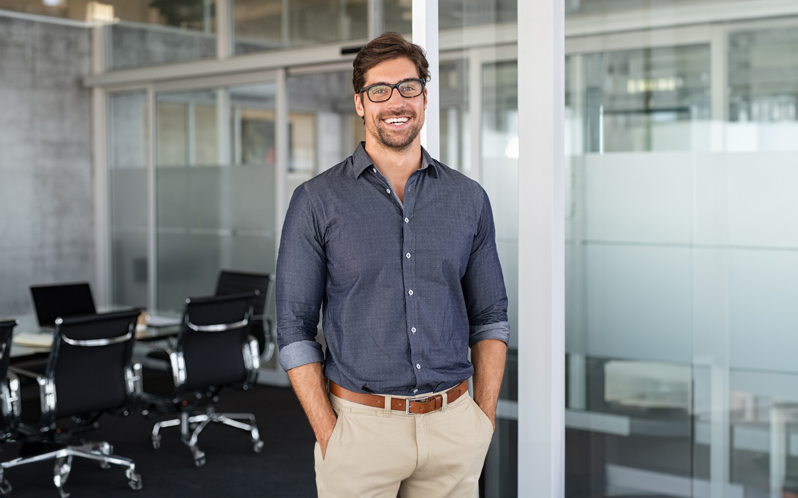 businessman-smiling-in-office-1189303518