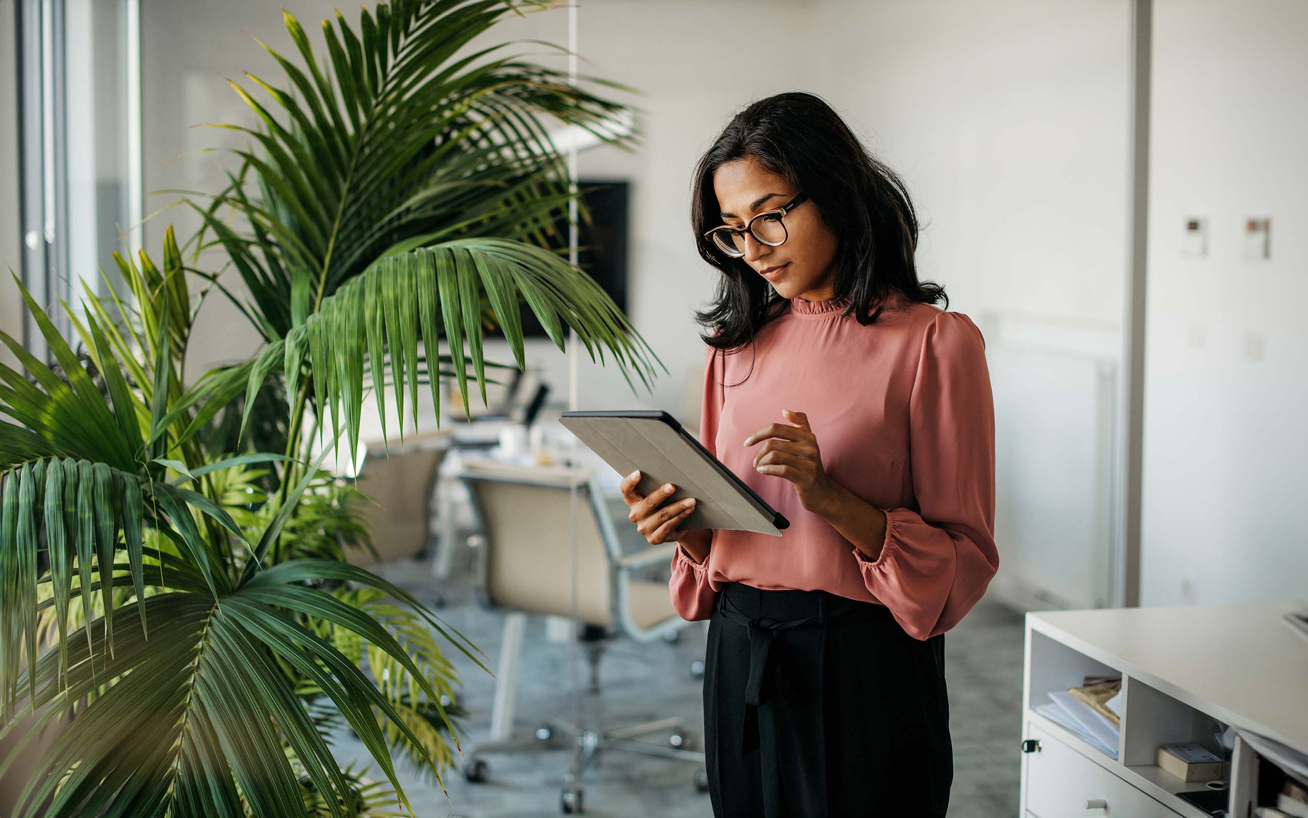 businesswoman-using-digital-tablet-1277533180