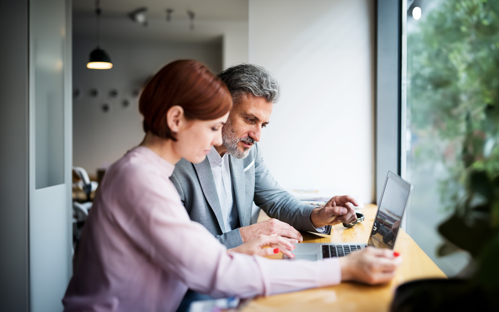 man-and-woman-having-business-meeting-in-a-cafe-using-laptop-1184142068