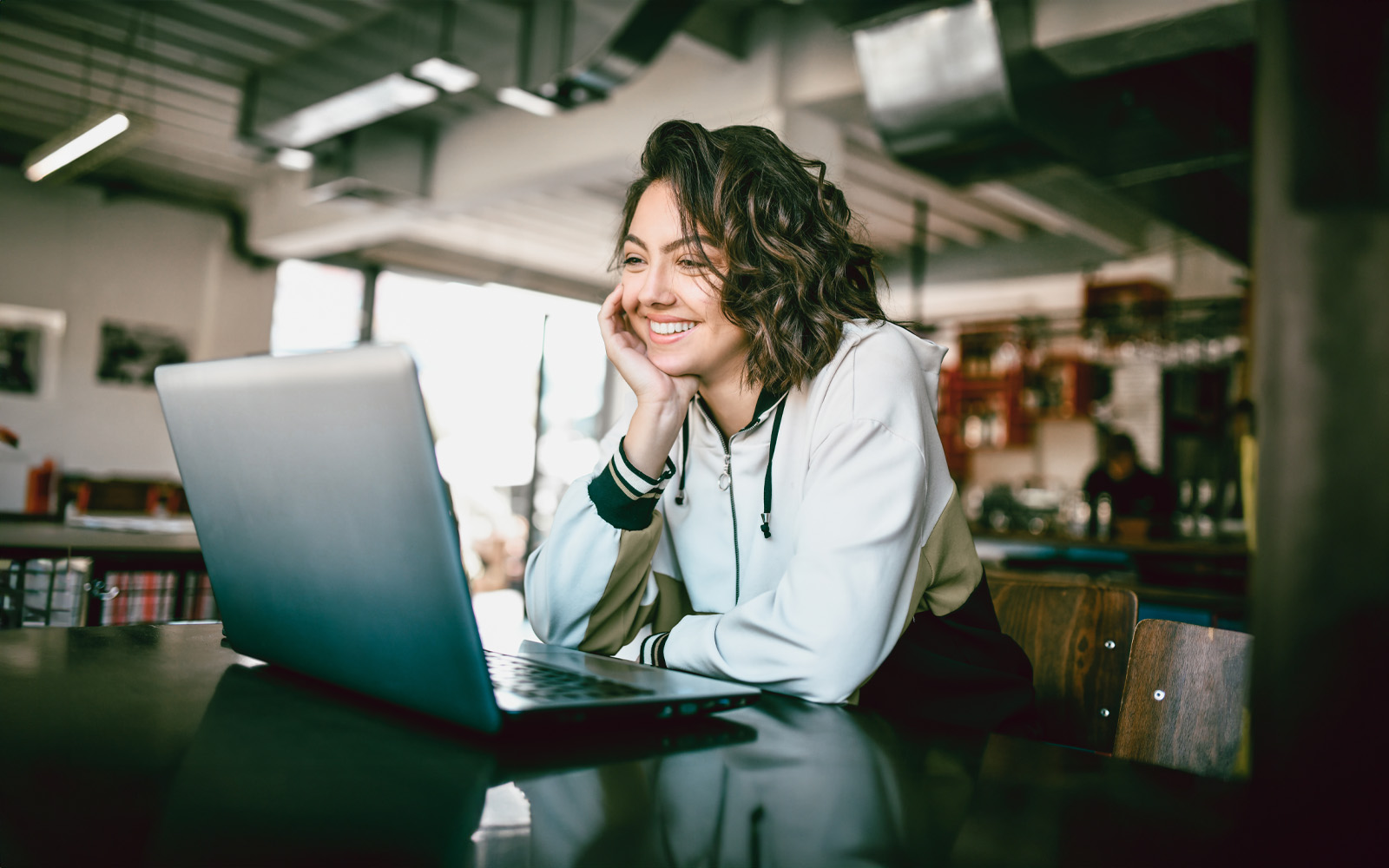 female-smiling-at-laptop-1183230942