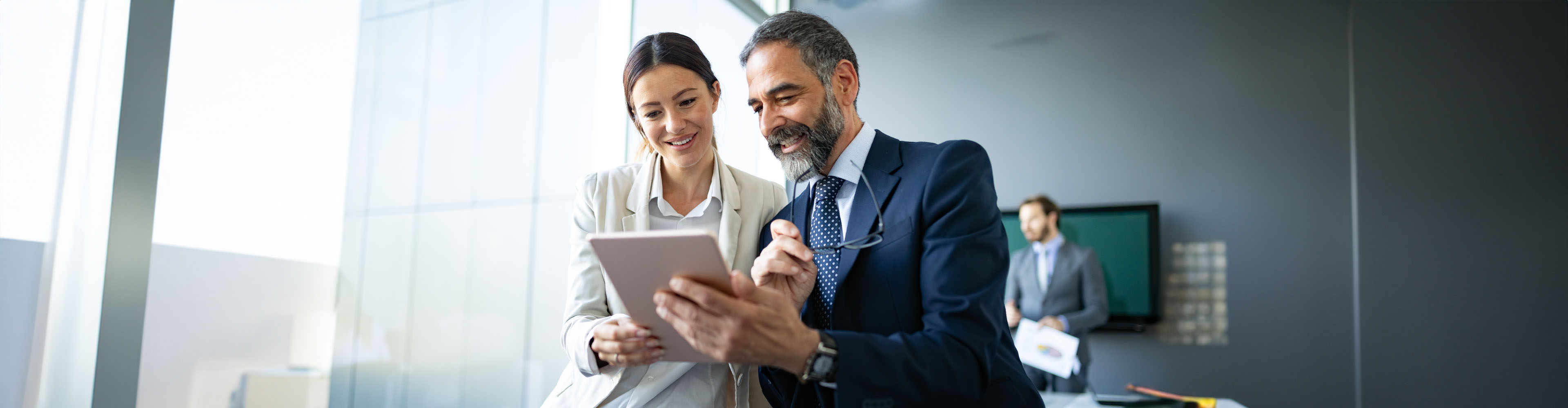 business-colleagues-in-office-using-tablet-1133767597-lp