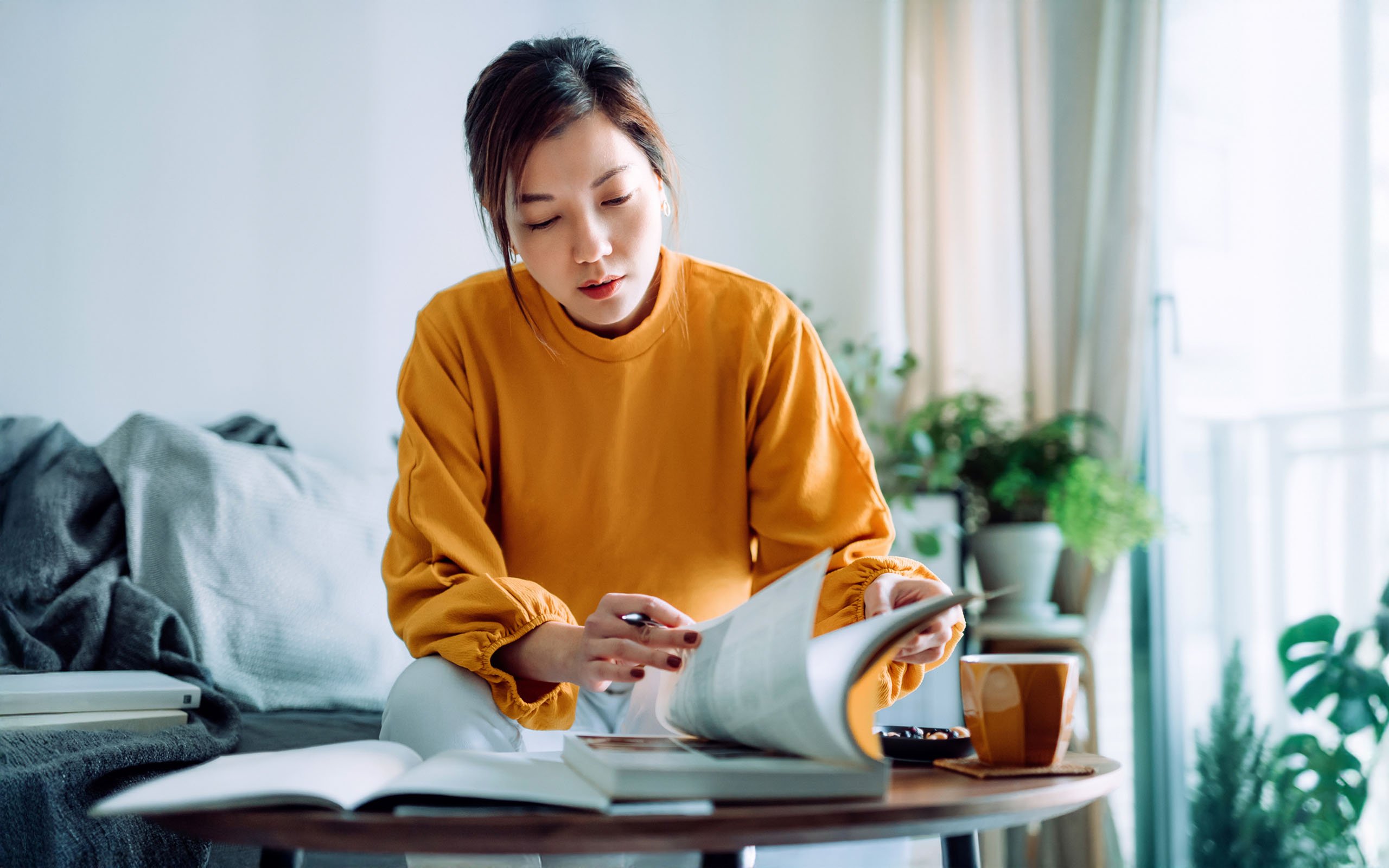 focused-young-woman-reading-book-1329209749
