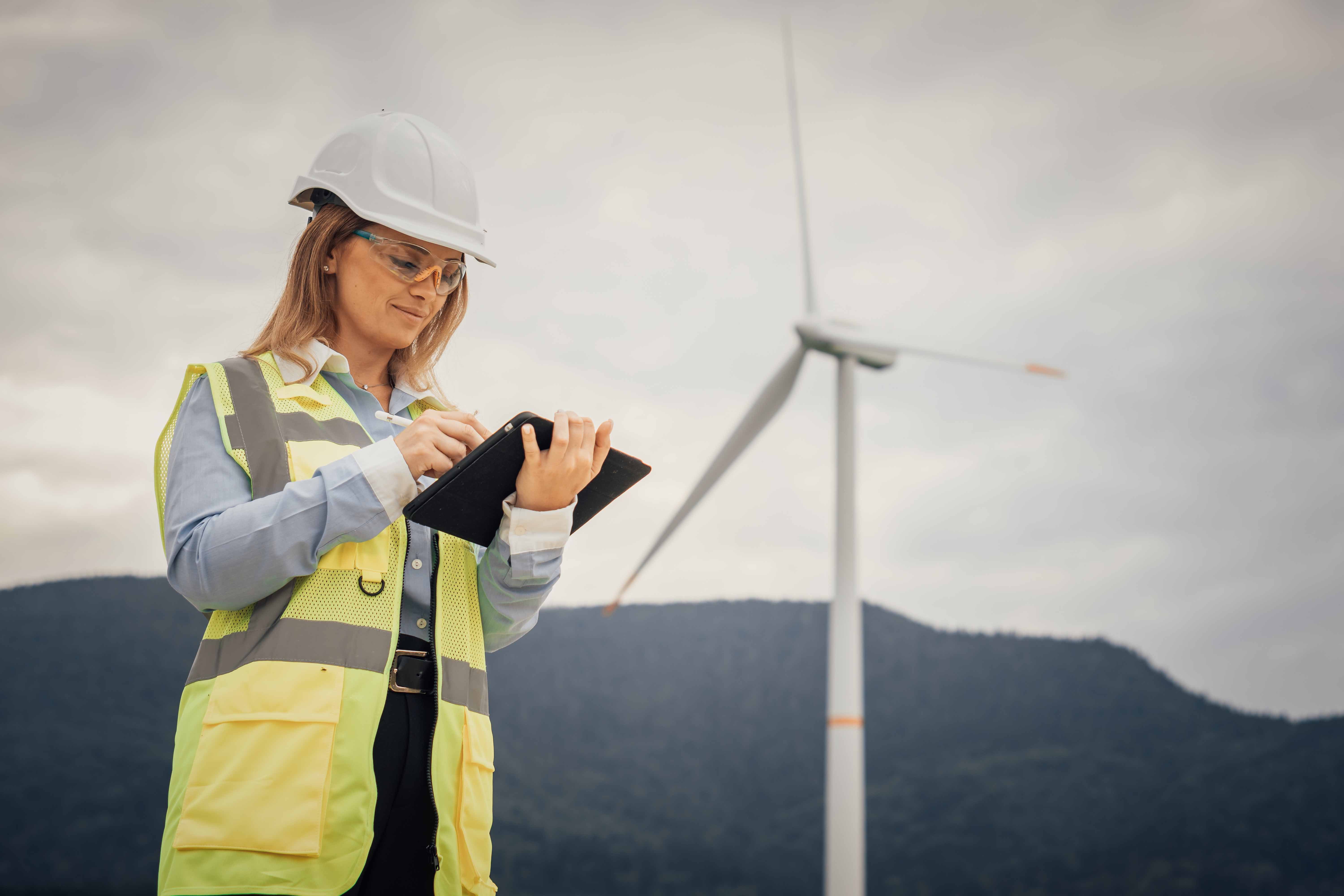 woman in the field in work clothes and laptop
